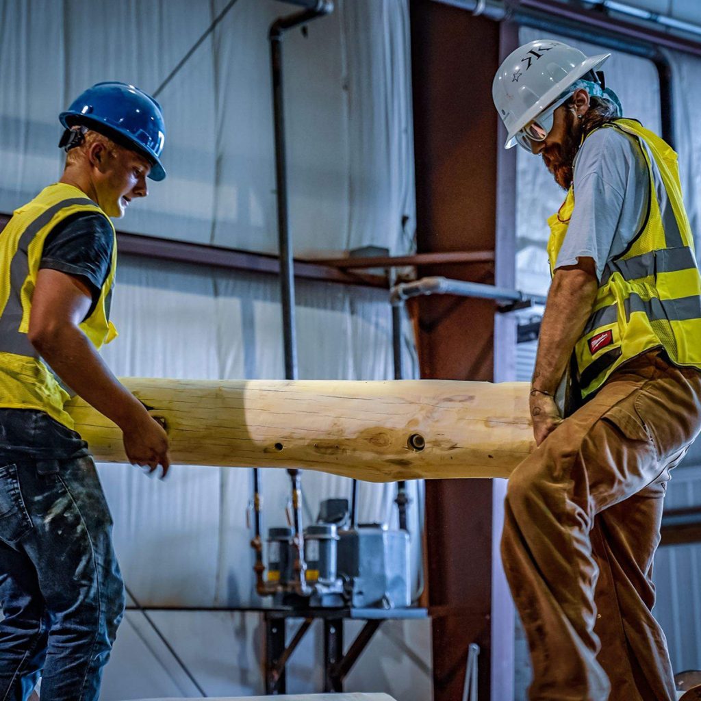 Endowment WholeTrees image of two men working with tree wood