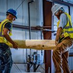 Endowment WholeTrees image of two men working with tree wood